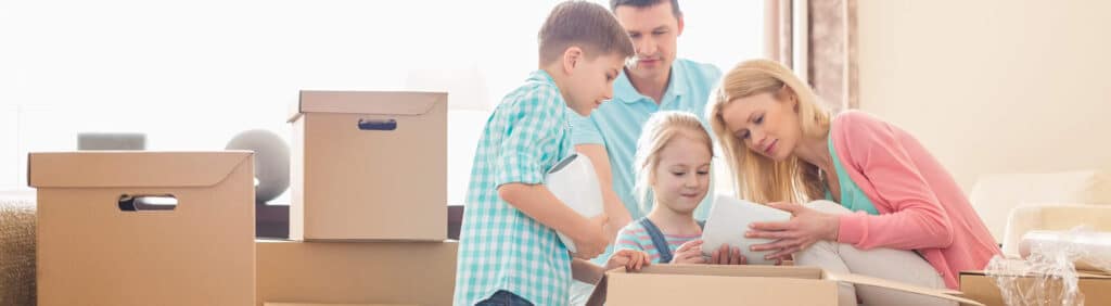 family packing moving boxes